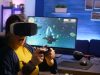 Winner gamer wearing virtual reality goggles, playing space shooter video games in room with RGB