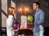 Smiley woman and man holding colorful bowling balls